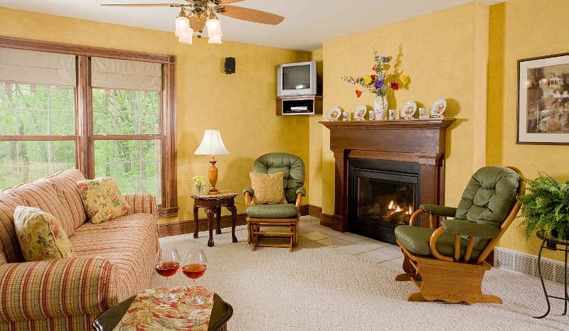 A comfortable living room with a fireplace, inviting seating, and a warm and inviting atmosphere.